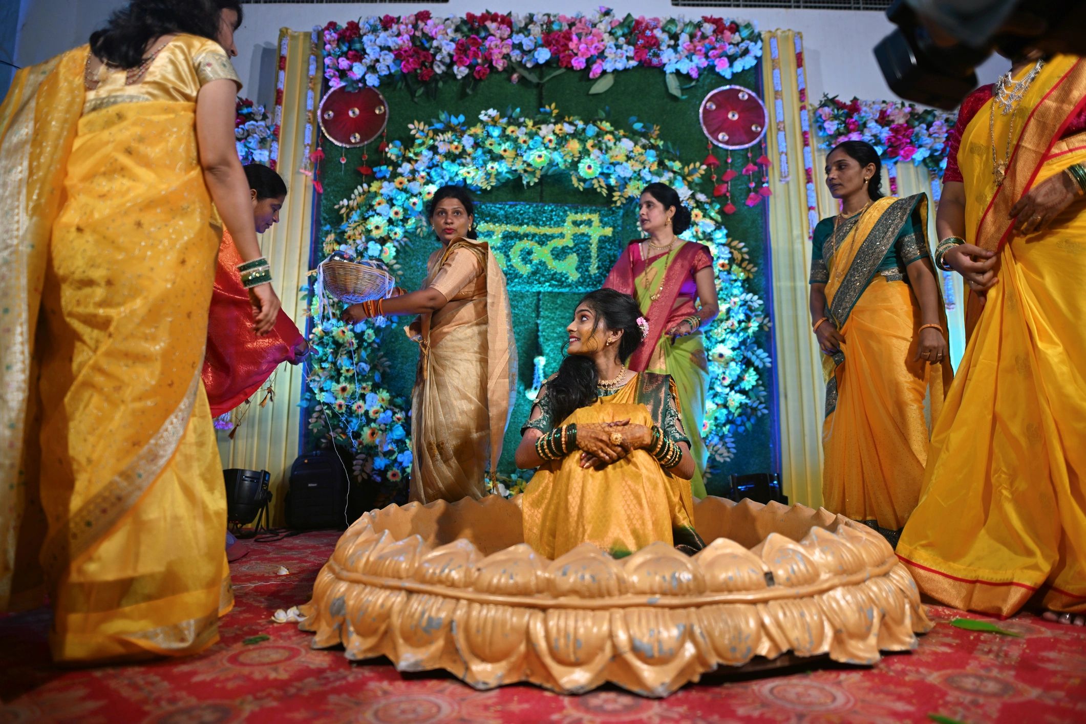 Bride surrounded by family during ceremonial celebration
