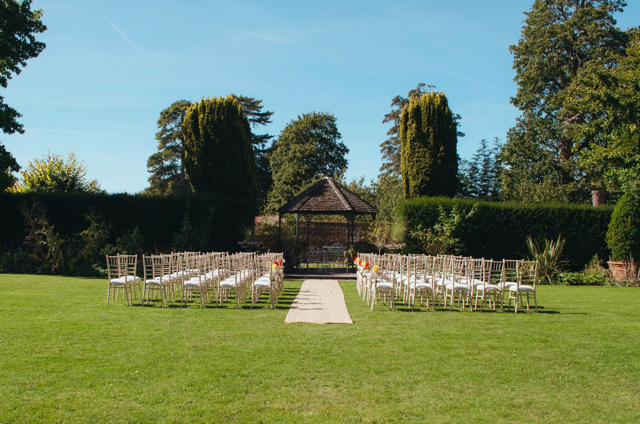 Elegant outdoor ceremony setup with floral decor and seating