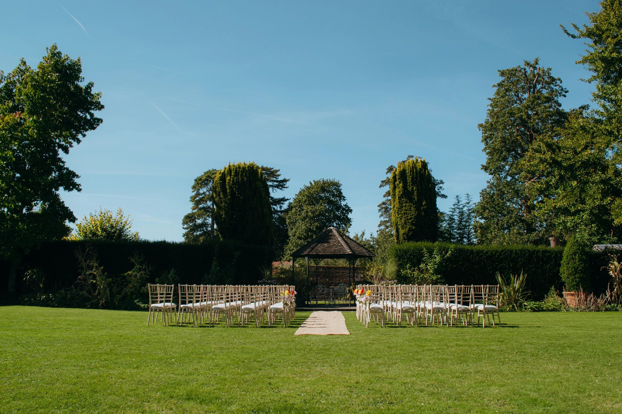Outdoor wedding ceremony layout with floral accents