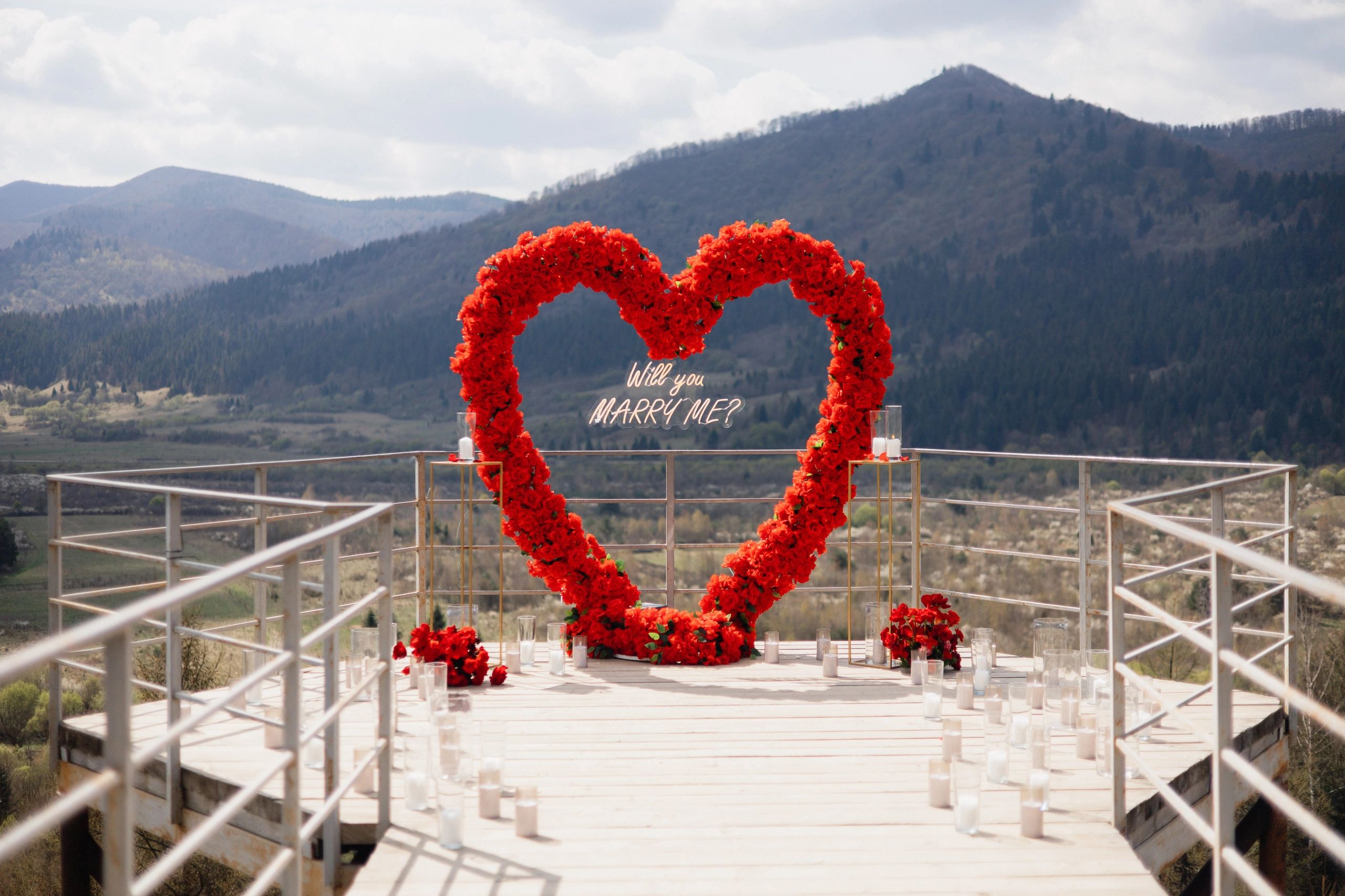 Romantic floral stage setup with scenic backdrop